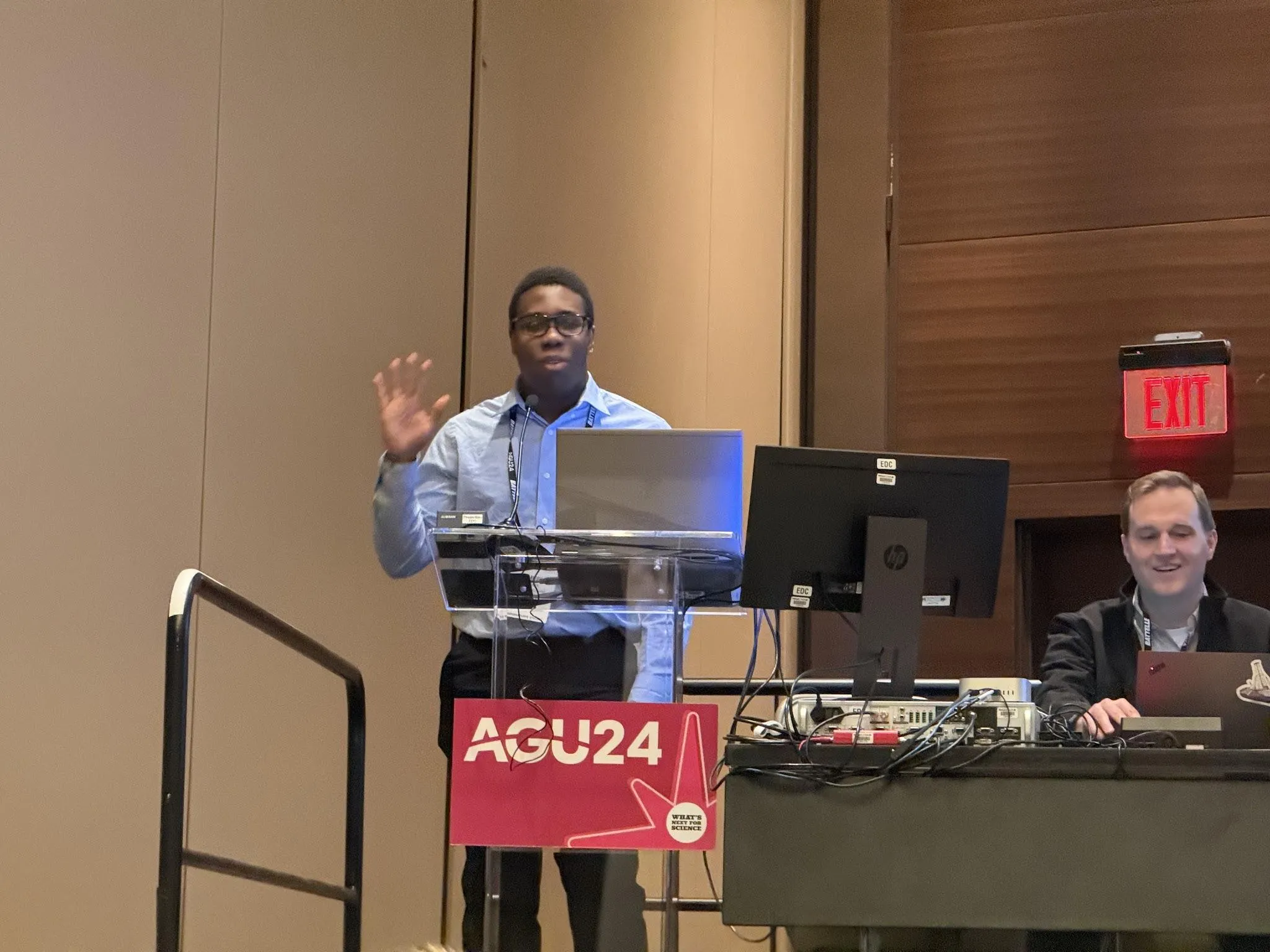 Samuel presenting his water cycle module at the podium.